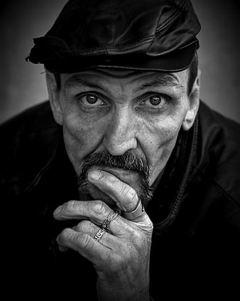 Intense Black and White Portrait of Man in Leather Cap