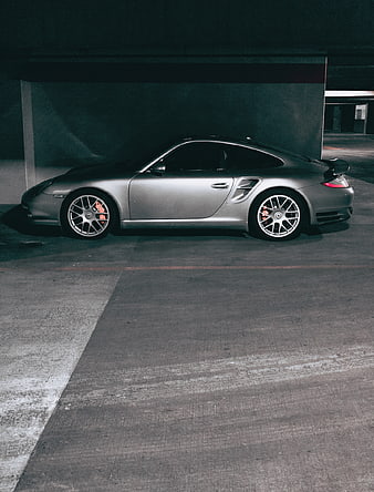 Silver Porsche 911 Turbo in dim parking garage