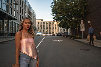 Stylish Blonde Woman in Pink Top on Urban Street