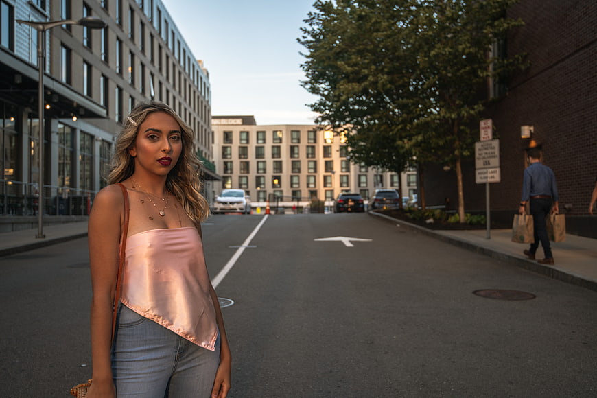 Stylish Blonde Woman in Pink Top on Urban Street