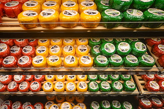 Colorful Dutch Gouda Cheese Wheels on Grocery Store Shelves