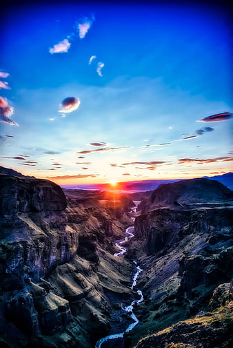 Dramatic Sunset Over Icelandic Canyon with Winding River