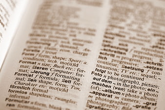 Close-up of open dictionary page with German and English definitions