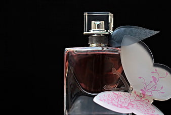 Elegant Perfume Bottle With Decorative Butterfly On Black Background