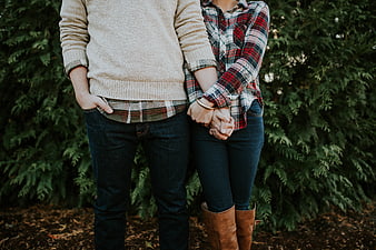 Couple holding hands in autumn plaid and denim