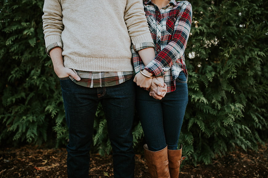 Couple holding hands in autumn plaid and denim