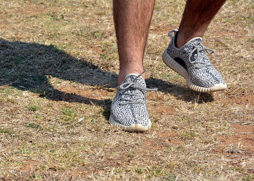 Close-up of running shoes on dry grass