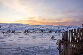 Serene Winter Sunset Landscape with Wooden Chair