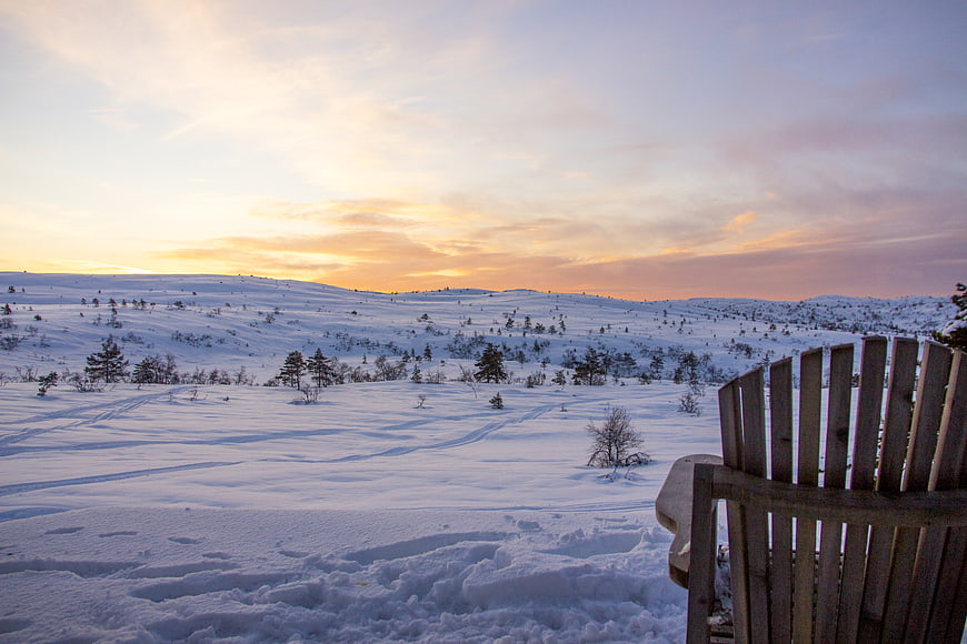 Serene Winter Sunset Landscape with Wooden Chair