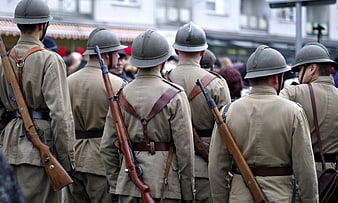 WWI Soldiers in Khaki Uniforms with Rifles and Helmets