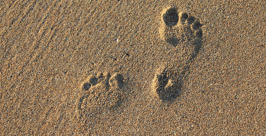 Barefoot Footprints in Sand on a Beach