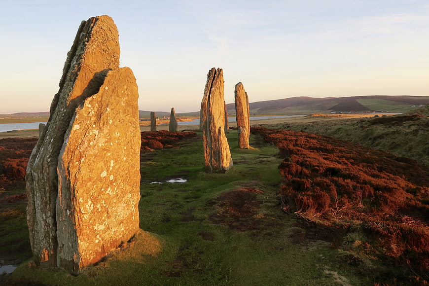 Ancient standing stones in Scottish landscape at golden hour