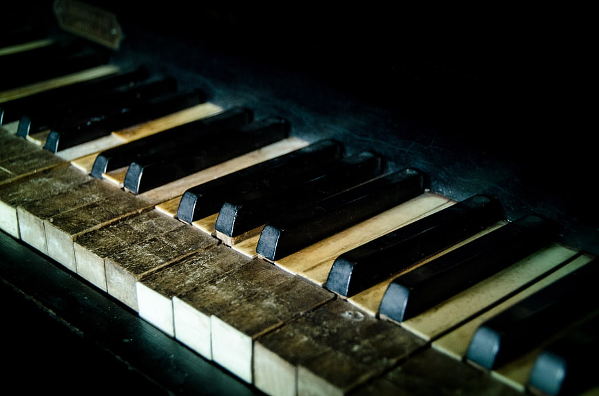 Close-up of vintage piano keys with worn texture