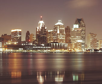 Detroit skyline at night with reflections on water