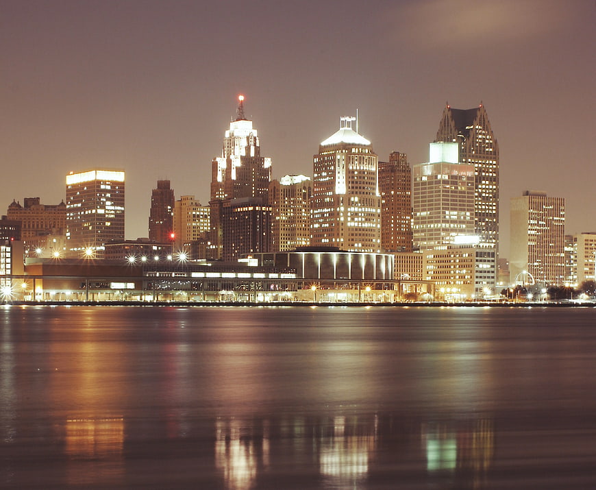 Detroit skyline at night with reflections on water