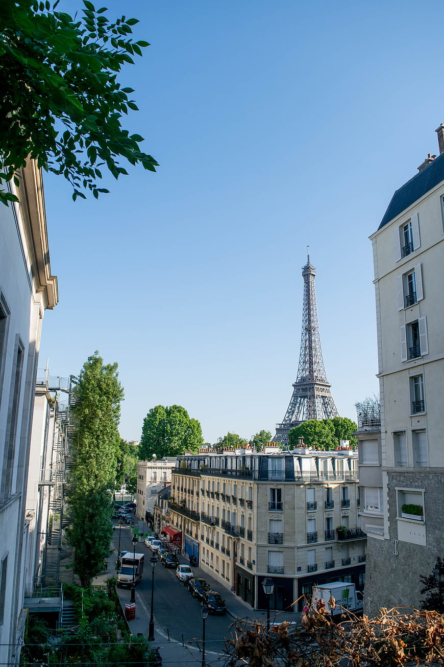 Paris street view with Eiffel Tower in distance