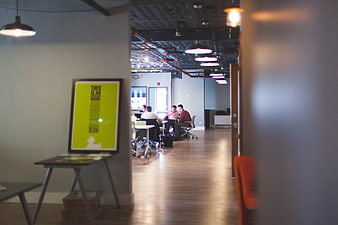 Modern office interior with team meeting and poster