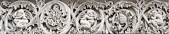 Medieval stone carving with cherubs and acanthus leaves