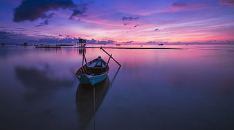 Traditional Balinese Boat at Sunset with Pink Sky