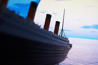 Titanic Model Ship Sailing on Ocean with Blue Sky