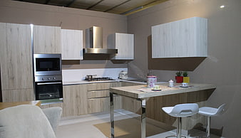 Modern kitchen interior with light wood cabinets and island