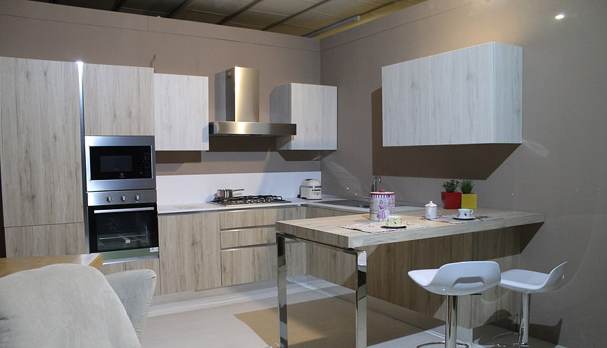 Modern kitchen interior with light wood cabinets and island