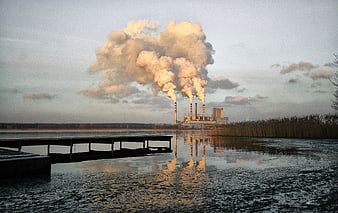 Industrial Power Plant Smokestacks Reflecting on Calm Lake Water