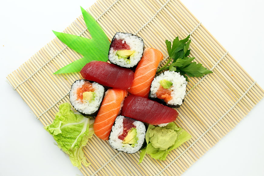 Fresh sushi assortment with salmon and tuna on bamboo mat