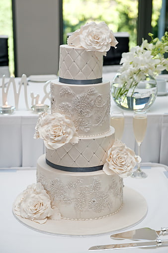 Elegant Four-Tier White Wedding Cake with Sugar Flowers