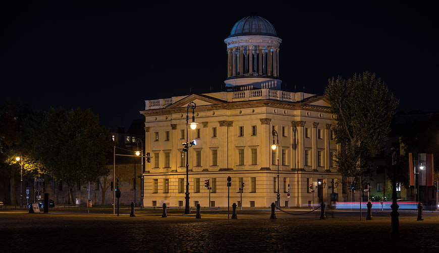 Illuminated neoclassical building with dome at night in Berlin