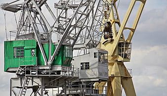 Industrial Port Cranes with Green and Yellow Cabins