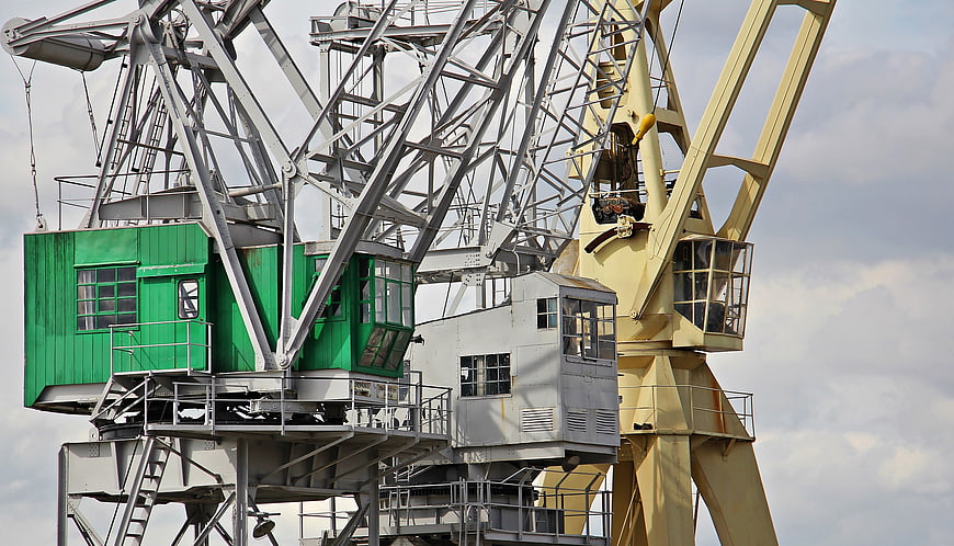 Industrial Port Cranes with Green and Yellow Cabins