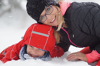 Happy Mother And Child Playing In Snowy Winter Landscape