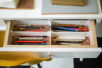 Organized drawer with colored pencils and art supplies