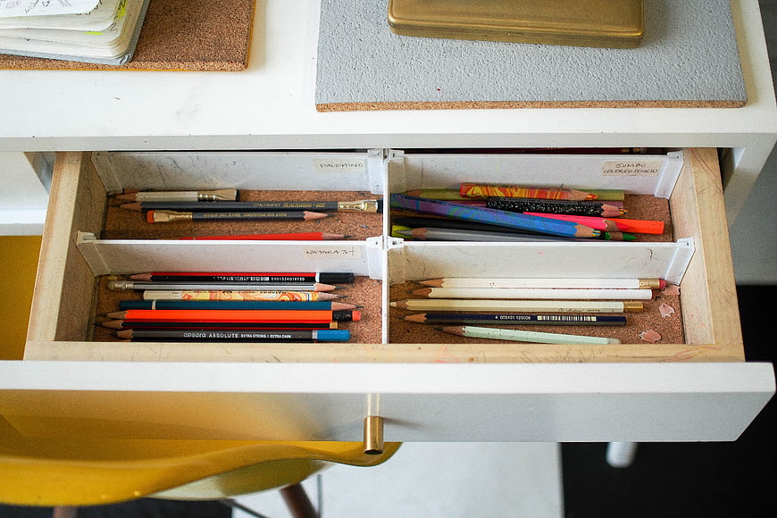 Organized drawer with colored pencils and art supplies
