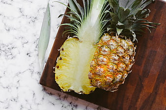 Fresh Halved Pineapple on Wooden Board