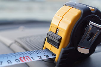 Yellow Tape Measure Close-Up On Car Dashboard