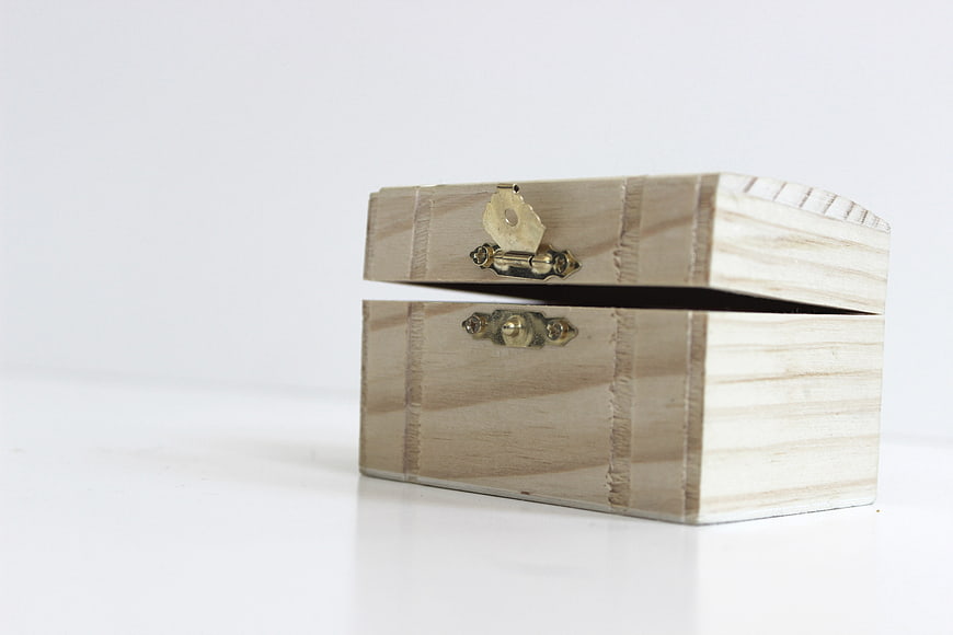 Open Wooden Treasure Chest with Brass Latch on White Background