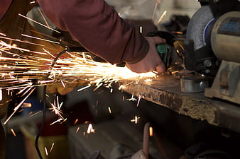 Close-up of metal grinding sparks flying in workshop