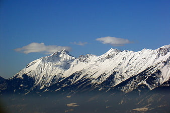 Snow-Capped Mountain Peaks Under Blue Sky