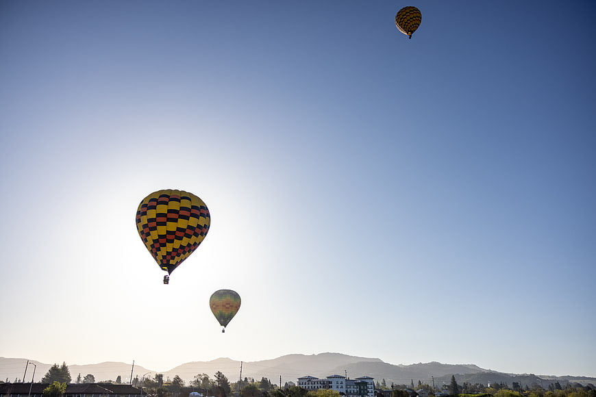 Colorful hot air balloons floating in blue sky
