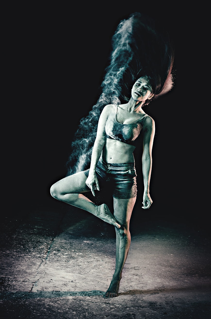 Woman in Tree Pose with Blue Powder Explosion