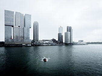 Modern City Skyline with Skyscrapers and Boat on Water