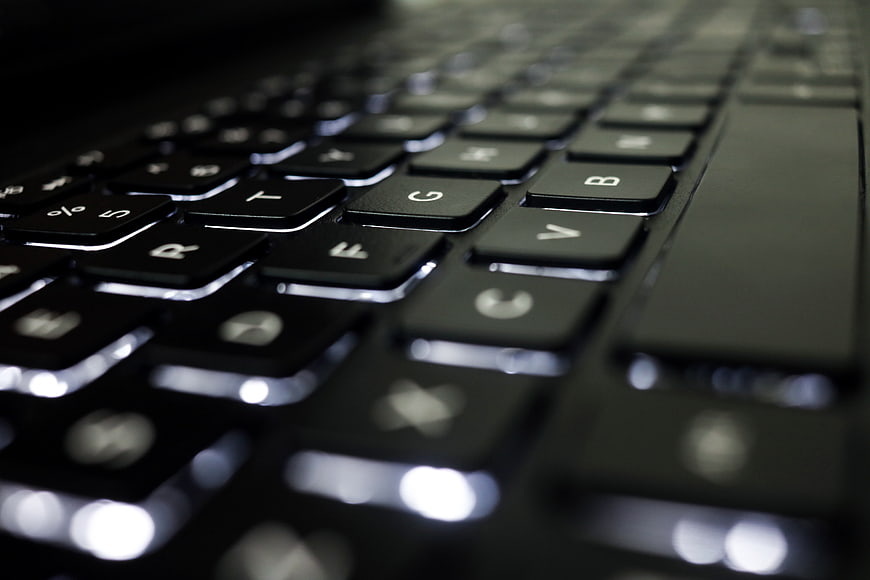 Close-up of black laptop keyboard with shallow depth of field