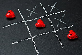 Red Hearts Winning Tic Tac Toe Game on Blackboard
