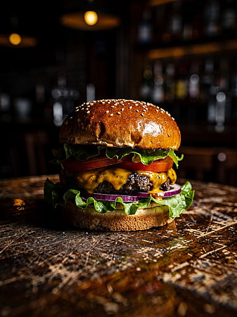 Juicy Gourmet Cheeseburger on Rustic Wooden Table