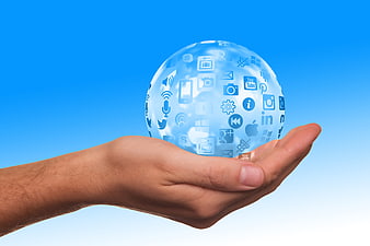 Hand holding digital globe with social media icons