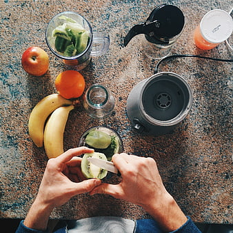 Top View of Hands Slicing Kiwi for Healthy Smoothie