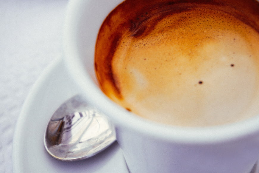 Close-up of creamy cappuccino coffee in white cup