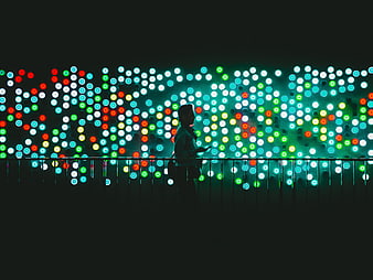 Silhouette of person against colorful bokeh lights at night